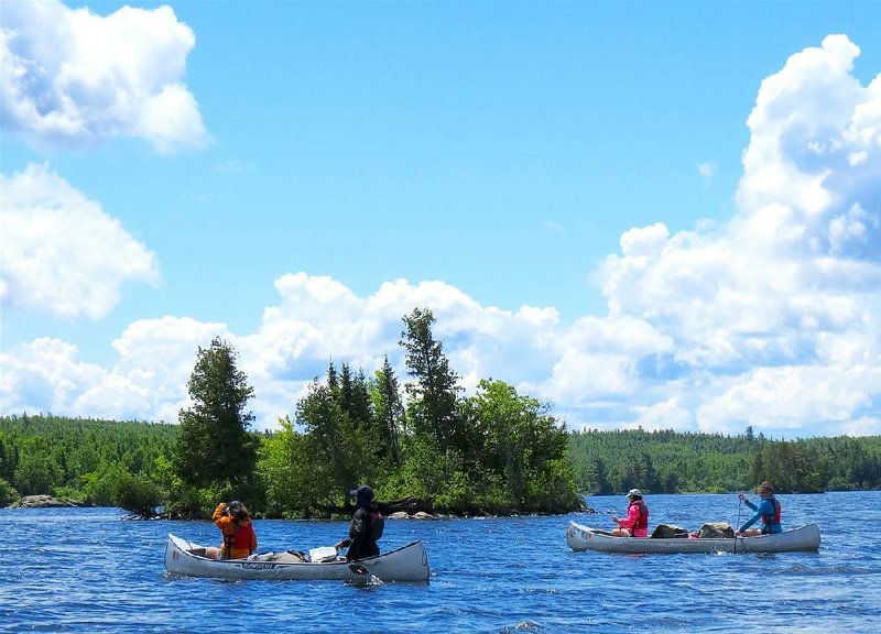 Canoeists paddle on Basswood Lake, one of more than 1,000 natural lakes in the Boundary Waters Canoe Area Wilderness of northern Minnesota. In all, it has about 1,500 miles of designated canoe routes.