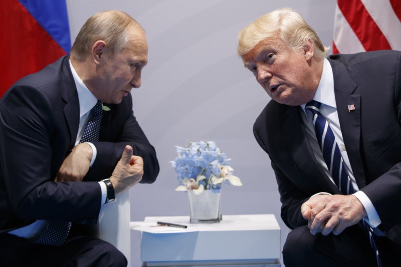 FILE - In this Friday, July 7, 2017, file photo U.S. President Donald Trump meets with Russian President Vladimir Putin at the G-20 Summit in Hamburg. A separate US-Russia-brokered truce for southern Syria, brokered by the U.S. and Russia, is meant to help allay growing concerns by neighboring Jordan and Israel about Iranian military ambitions in the area. (AP Photo/Evan Vucci, File)