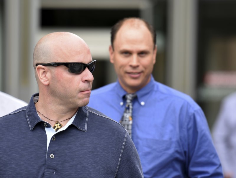 Former Chicago police officer Joseph Walsh, left, and Chicago police officer Thomas Gaffney, right, depart the Cook County Courthouse after their arraignment on state felony charges of conspiracy in the investigation of the 2014 shooting death of Laquan McDonald Monday, July 10, 2017, in Chicago. The indictment marks the latest chapter in the history of a police force dogged by allegations of racism and brutality against the city's black residents. Both pled not guilty on all charges.