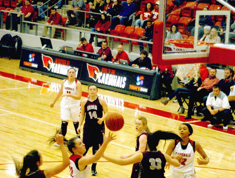 MARK HUMPHREY ENTERPRISE-LEADER Three Farmington players, shown competing against Siloam Springs, earned post-season honors. MaKenna Vanzant (shooting) received 5A West All-Conference, All-State, and All-State Tournament team selections. Kaylee Brown (No. 12 moving in for rebound) was named 5A West All-Conference, and honorable mention All-State. Camryn Journagan (top of the key) was named 5A West All-Conference. Madisyn Pense (not pictured) was voted 5A West All-Conference.