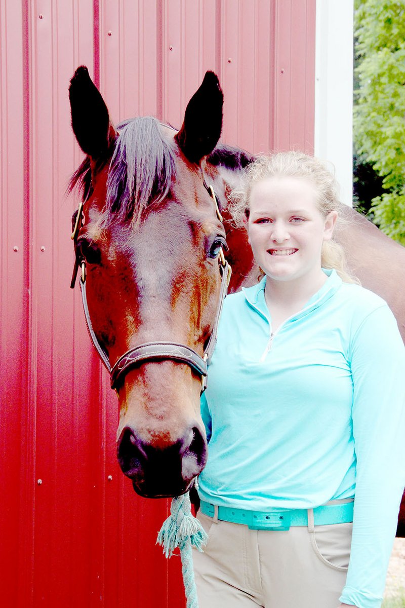 LYNN KUTTER ENTERPRISE-LEADER Cherrill Davis, 13, stands with one of the horses from Davis Stable in Fayetteville. This is Regal Signature or Regis, an Appendix quarter horse, which means he&#8217;s one-half quarter horse and one-half thoroughbred.