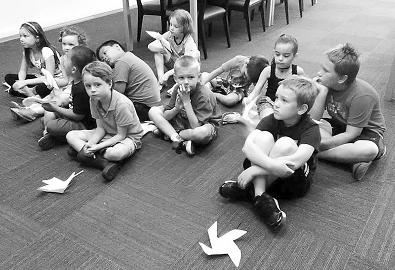 Submitted Photo Children made a pinwheel as a craft and then listened about weather and predicting storms during the summer reading session at the Gentry Public Library on Monday, June 19.