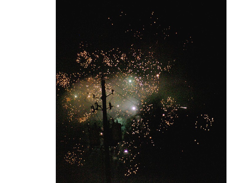 MARK HUMPHREY ENTERPRISE-LEADER This power pole accompanied by electrical lines resembles a ship&#8217;s mast and rigging illuminated by fireworks during Celebrate Prairie Grove held at the aquatic park Saturday. Francis Scott Key may have beheld a similar vision during the bombardment of Fort McHenry which inspired him to write the Star Spangled Banner.