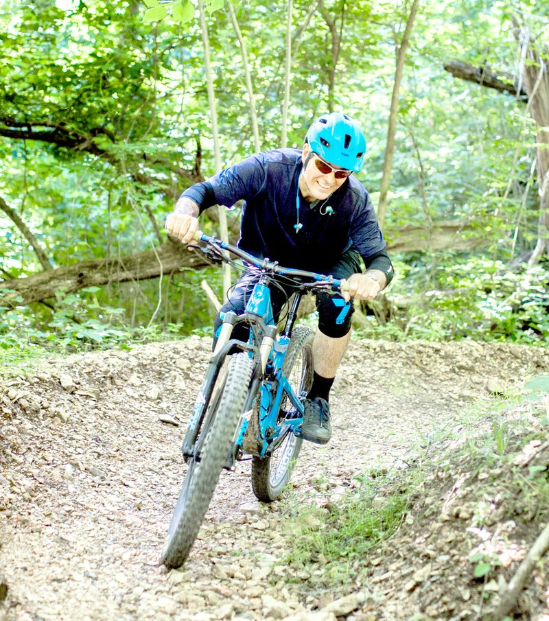 Photo submitted A mountain-bike rider pedals around a curve on the Back 40 trails in Bella Vista.