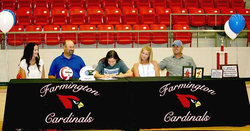 MARK HUMPHREY ENTERPRISE-LEADER Kaylynn Bates, a 2017 Farmington graduate, signs a national letter of intent to play women&#8217;s college volleyball for Rockhurst University, of Kansas City, Mo. Bates was accompanied by her family during the ceremony Monday at Cardinal Arena. From left: Kristin Bates, stepmother; Geoff Bates, father; Kaylynn Bates; Kim Krueger, mother; and Jeremy Krueger, stepfather.