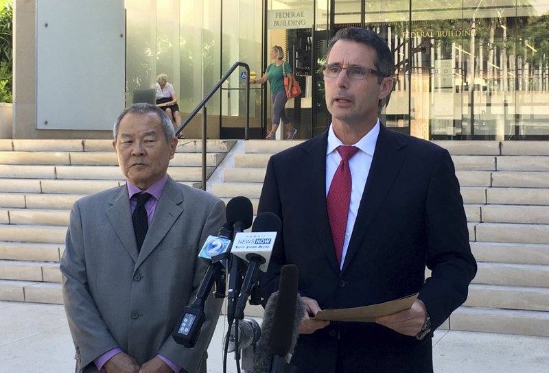 Paul Delacourt, the FBI special agent in charge of the Hawaii bureau, right, speaks at a news conference as Acting United States Attorney Elliot Enoki, left, listens outside federal court in Honolulu, Monday, July 10, 2017. An active duty soldier based in Hawaii pledged his allegiance to the Islamic State group, helped purchase a drone for it to use against American forces and said he wanted to use his rifle to "kill a bunch of people" according to an FBI affidavit. Ikaika Kang, a sergeant first class in the U.S. Army, made an initial appearance Monday in federal court in Honolulu. He was arrested Saturday on terrorism charges. (AP Photo/Caleb Jones)