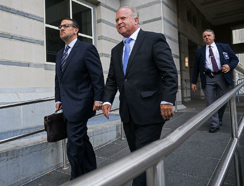David Wildstein (left), with his attorney, Alan Zegas, leaves federal court in Newark, N.J., on Wednesday after being sentenced for his role in the 2013 George Washington Bridge lane-closing scheme. 
