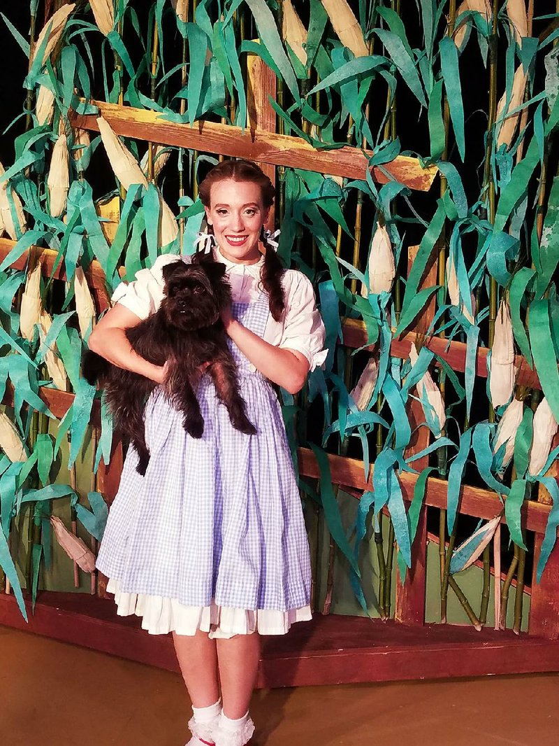 Katherine Yacko plays Dorothy and Archie plays Toto in The Wizard of Oz at Murry’s Dinner Playhouse.

