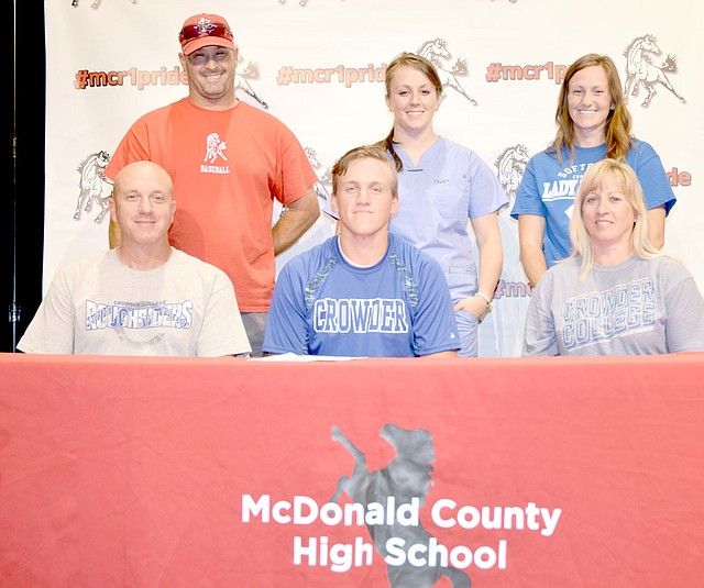 Photo by Rick Peck McDonald County High School graduate Jaime Hanke (bottom, center) is flanked by his parents Bill and Gayle Hanke as he signs a letter to play baseball at Crowder College. Back row, left to right: Nick Martin, MCHS baseball coach, and sisters, Julie Grimes and Johnica Hanke.