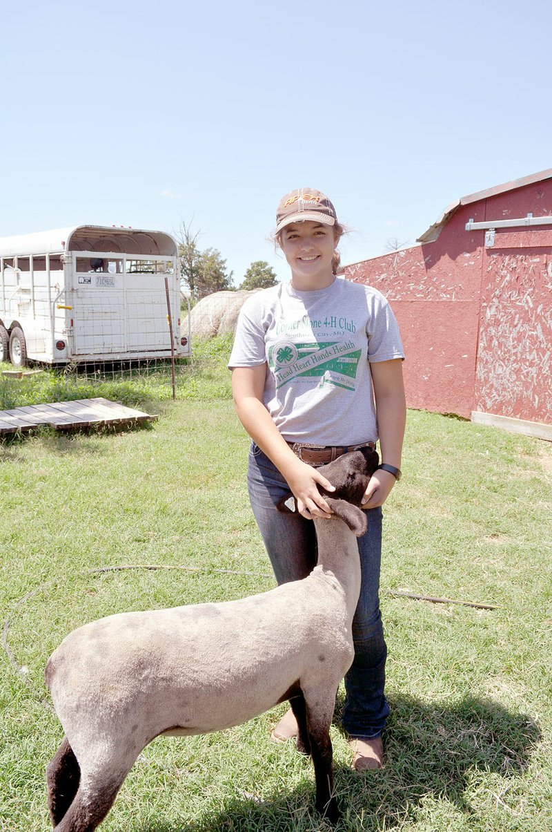 RACHEL DICKERSON/MCDONALD COUNTY PRESS Callie Thacker is pictured with her sheep, Rose. She will be showing Rose and other sheep in the McDonald County Fair.