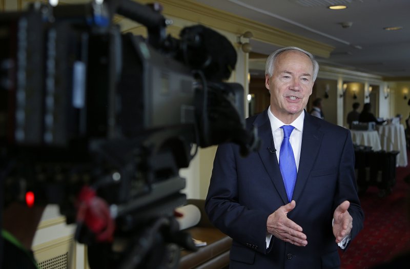 Arkansas Republican Gov. Asa Hutchinson discusses the health care bill under consideration by the U.S. Senate during a television news interview on the first day of the National Governor's Association meeting Thursday.