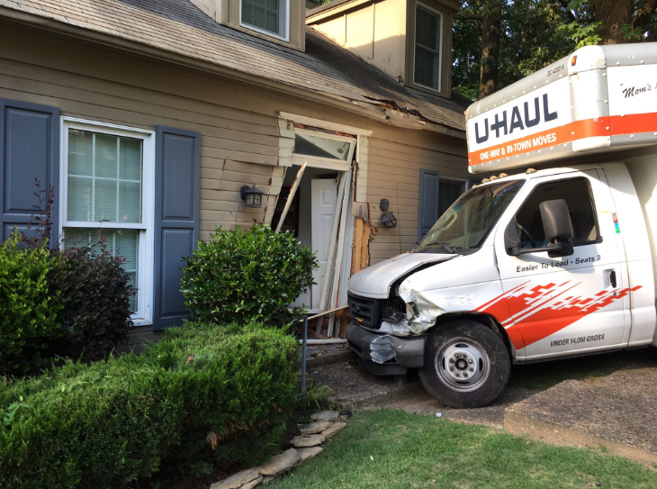 A moving truck is seen crashed into the front of a house in this photo taken by the Little Rock Police Department.