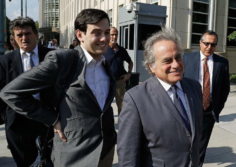 Former biotech chief executive Martin Shkreli (center left) follows his attorney Benjamin Brafman as they leave federal court Monday in Brooklyn, N.Y.

 