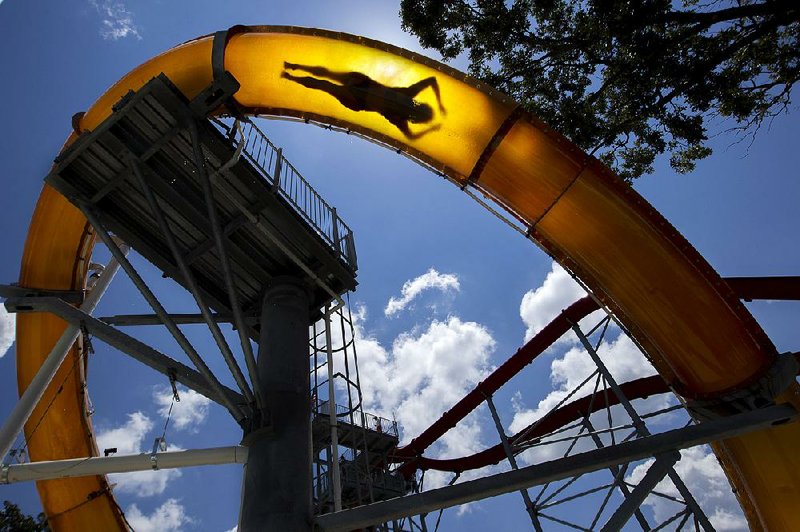 FILE — Dejean Still, from Eudora, Miss., shoots through the AquaLoop tube ride at Wild River Country in North Little Rock in 2017. 