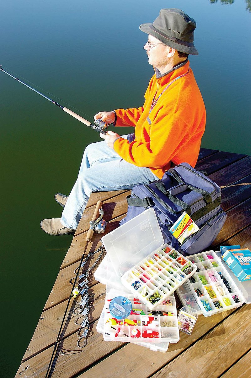A big tackle bag that holds several plastic boxes with dividers, like the one used here by Lewis Peeler of Vanndale, is ideal for carrying the many lures, hooks, bobbers and other small items of tackle used by most crappie anglers.