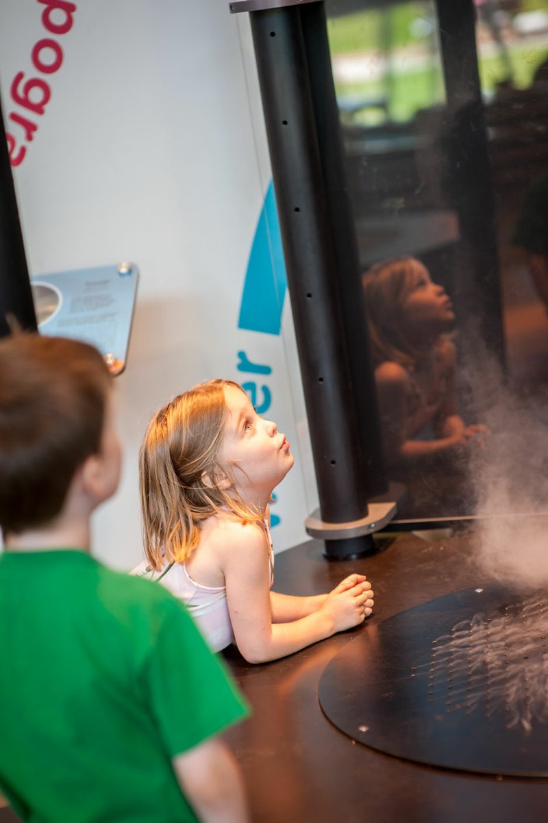 NWA Democrat-Gazette/Lara Jo Hightower Emme loved watching the tornado form in the Energizer Weather and Nature exhibit.