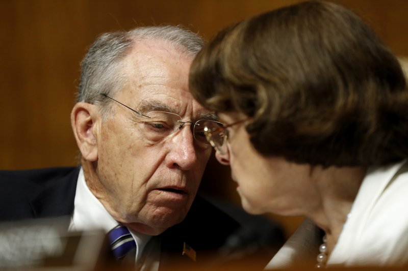 Senate Judiciary Committee Chairman Sen. Chuck Grassley, R-Iowa, talks with the Committee's ranking member Sen. Dianne Feinstein, D-Calif., on Capitol Hill in Washington, Wednesday, July 12, 2017, during the committee's confirmation hearing for FBI Director nominee Christopher Wray. 