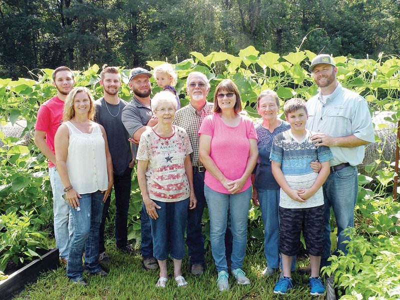 The Lynn Pye family of the Shakertown community is the 2017 Clark County Farm Family of the Year. Members of the family include, front row, from left, Mindy Burns, Marjorie Cagle Pye, Debbie Pye and Kasey Pye; back row, Hunter Mayhue, Cameron Mayhue, Robert “Bobby” Pye, Penelope Pye, Lynn Pye, Barbara Ray and Jason Pye. The Pyes raise hay, cows and produce, including the gourds shown in this photograph.