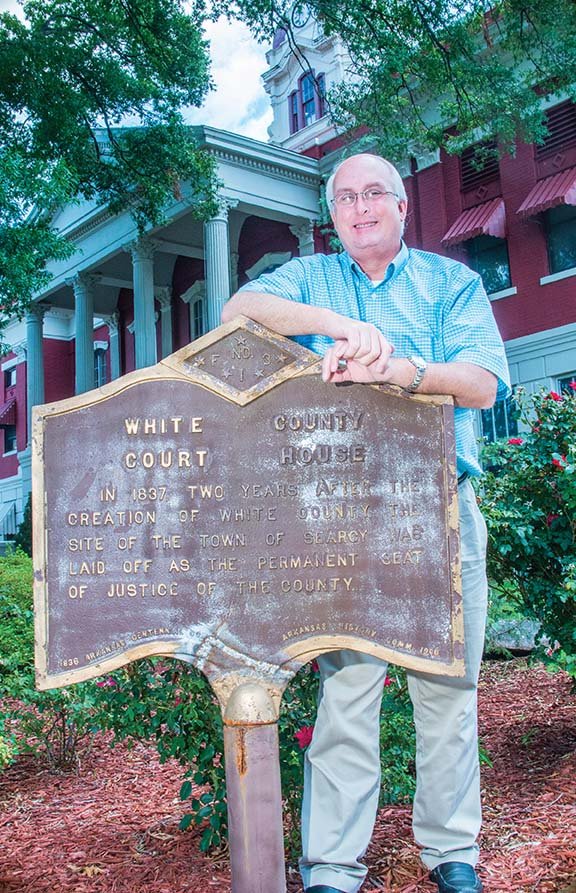 Revis Edmonds, preservation outreach coordinator for the Arkansas Historic Preservation Program, stands in front of the White County Courthouse as he prepares for the Walks Through History tour. The 11-stop tour will take place Saturday in Searcy.