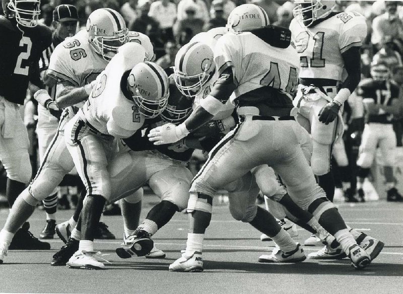 Defenders for The Citadel swarm Arkansas running back E.D. Jackson during the NCAA Division I-AA Bulldogs’ 10-3 victory  over the Razorbacks at Fayetteville in 1992. It was a grisly loss for the Razorbacks in their first game as a member of the SEC and it resulted in coach Jack Crowe’s firing the next day.