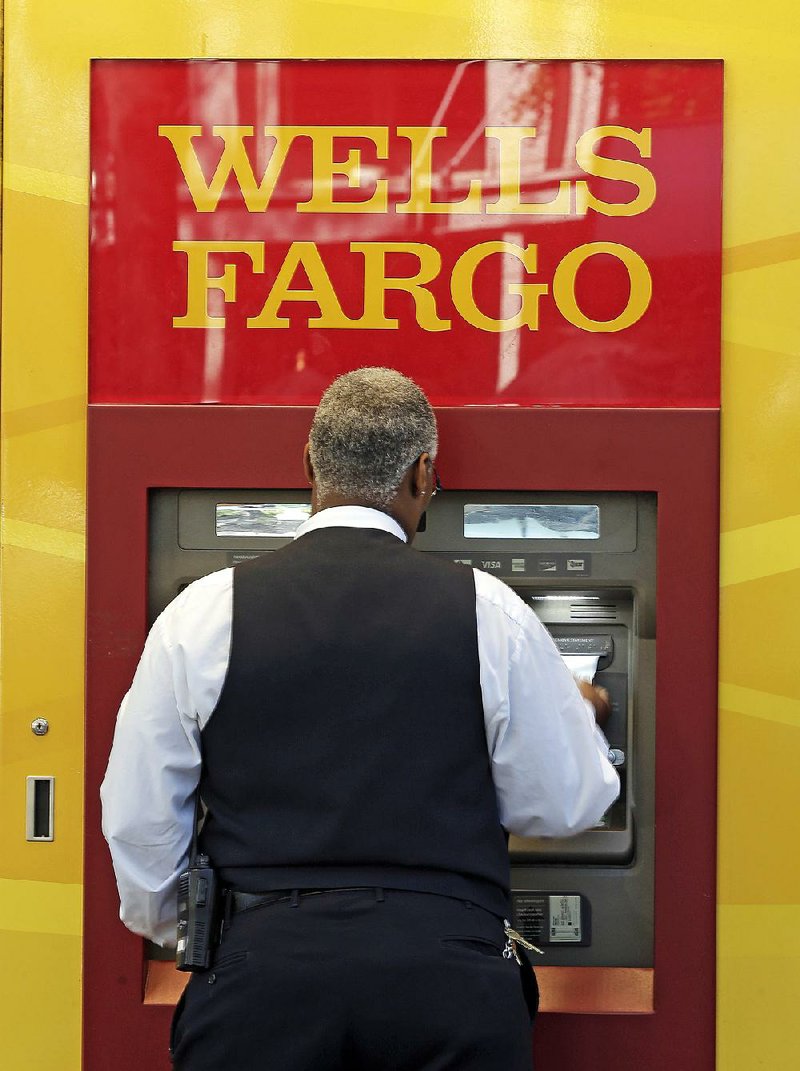 A customer uses a Wells Fargo ATM in Charlotte, N.C., in April. 