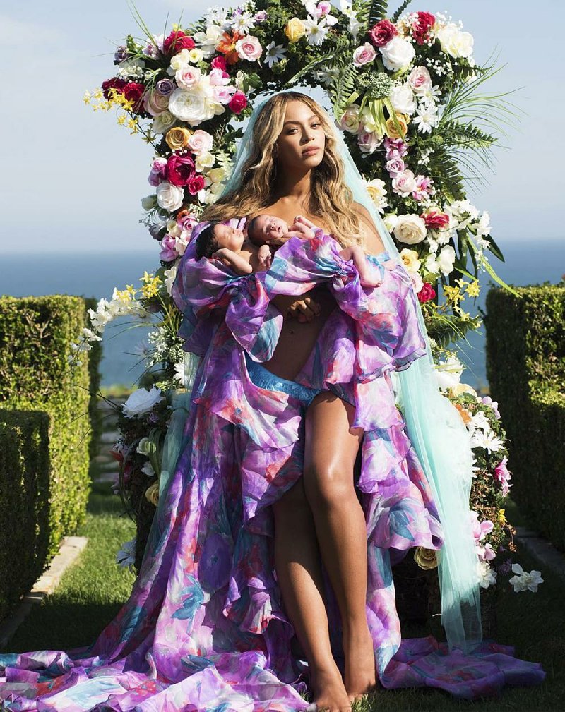 In this undated image released by Parkwood Entertainment on Friday, July 14, 2017, Beyonce posed with her newborn twins Sir Carter and Rumi. The singer posted the picture on Instagram late Thursday night and wrote in the caption, "Sir Carter and Rumi 1 month today."