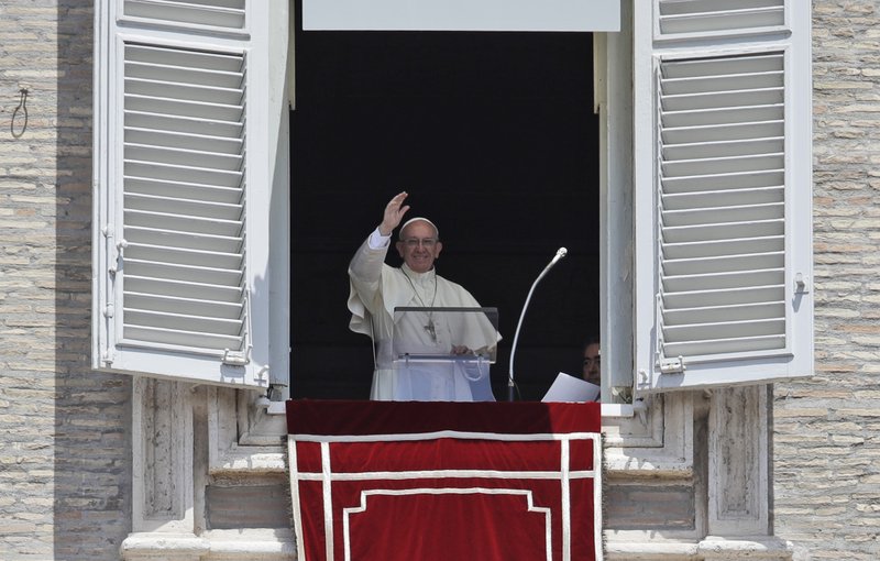 Pope Francis waves to the crowd as he prepares to recite the Angelus noon prayer from the window of his studio overlooking St.Peter's Square, at the Vatican, Sunday, July 9 , 2017. (AP Photo/Alessandra Tarantino)