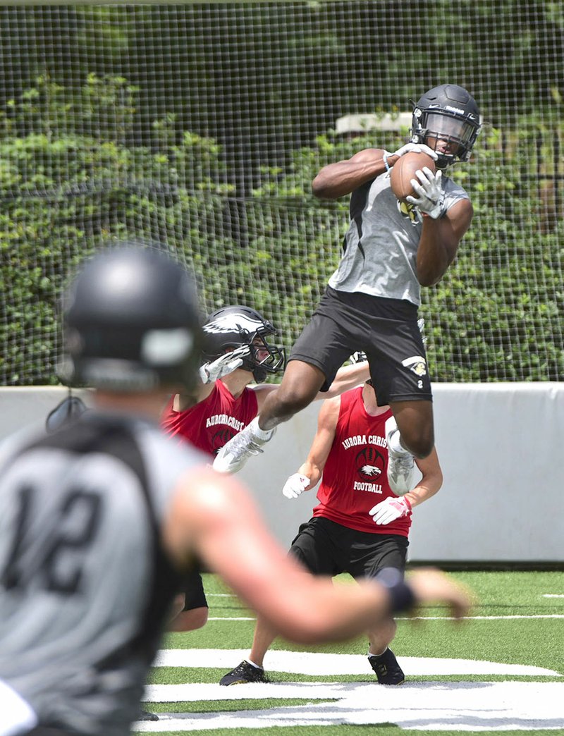 Kam’Ron Mays-Hunt of Bentonville High catches a pass Friday against Aurora Christian during the Southwest Elite 7-on-7 tournament at Jarrell Williams Bulldog Stadium in Springdale.