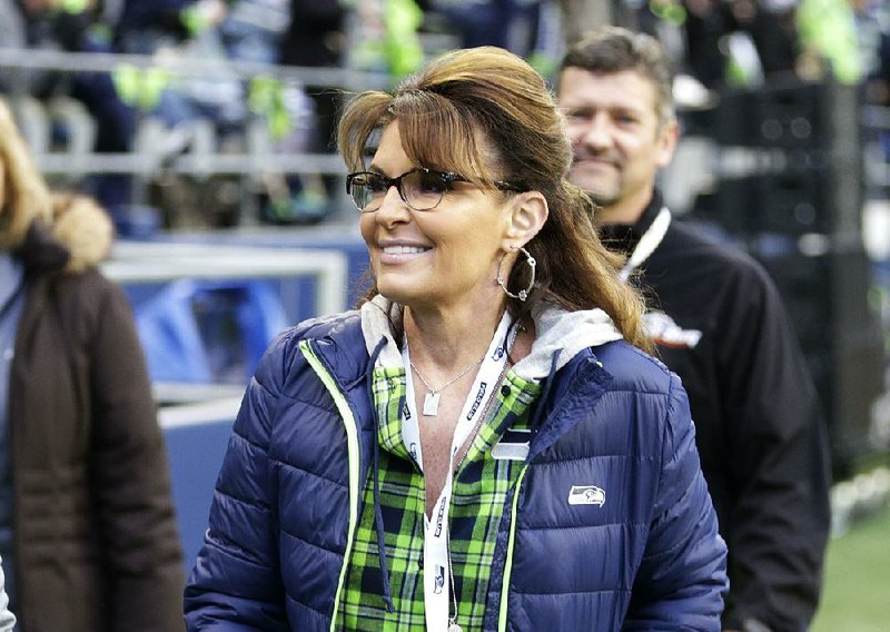 In this Dec. 15, 2016, file photo, Sarah Palin, political commentator and former governor of Alaska, walks on the sideline before an NFL football game between the Seattle Seahawks and the Los Angeles Rams in Seattle. 