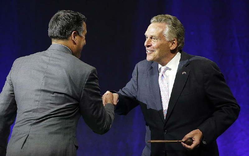 Govs. Brian Sandoval (left), a Nevada Republican, and Terry McAuliffe, a Virginia Democrat, attend the closing session Saturday of the National Governors Association meeting in Providence, R.I. The nation’s health care system was front and center at this summer’s session. 