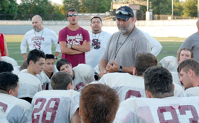 Graham Thomas/Siloam Sunday Siloam Springs football coach Bryan Ross speaks to the Panthers after hosting a football team camp with Gravette and Farmington on Thursday at Panther Stadium.