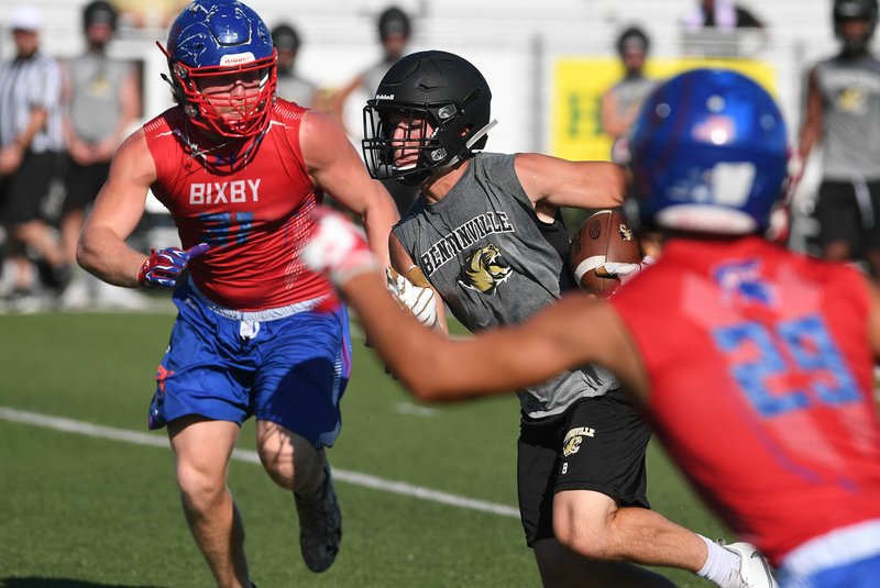 NWA Democrat-Gazette/J.T. WAMPLER Bentonville’s Easton Miller looks for running room between a pair of Bixby defenders Saturday during the annual Southwest Elite 7-on-7 tournament at Shiloh Christian Saturday.