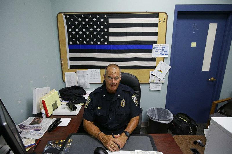Lt. Paul Roderick sits at his desk at police headquarters in Taunton, Mass., last week. Police departments are increasingly using Facebook to inform their communities about what they’re doing and who they’ve been arresting.