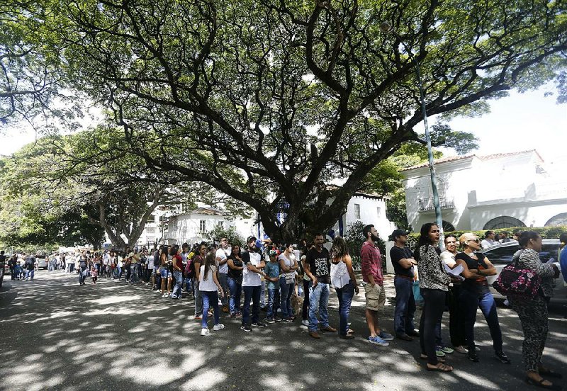 People line up to cast their ballots at a polling station in Caracas, Venezuela, during a symbolic referendum
against rewriting the nation’s constitution.