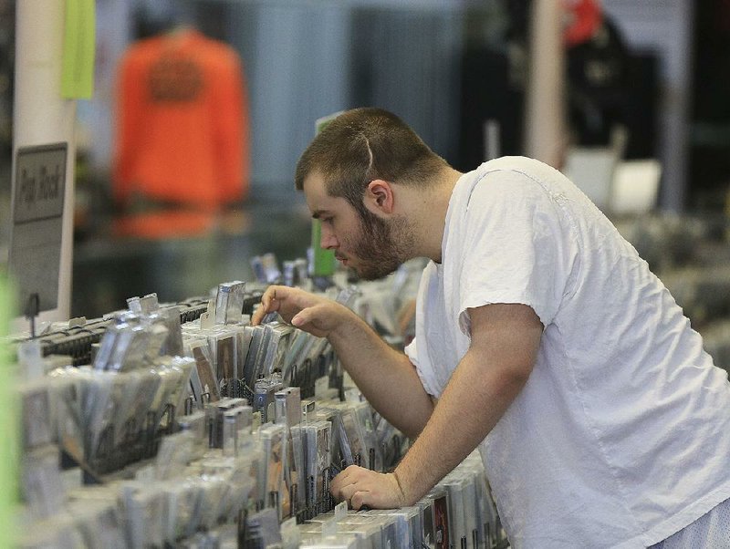 Caleb Oakley of White Hall shops Wednesday at the Record Rack in Pine Bluff.
