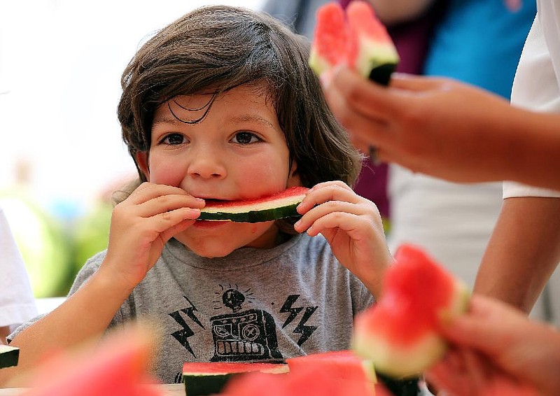 Arkansas Democrat-Gazette/THOMAS METTHE -- 7/16/2017--
Elliott Quintanar, 4, finishes off a slice of watermelon in the watermelon eating contest during the watermelon festival at Bernice Gardens Farmers' Market on Sunday, July 16, 2017. 