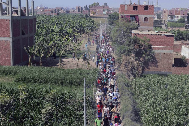 People carry the body of Sayed Tafshan, who died during clashes between security forces and residents of al-Waraq island, on the southern fringes of Cairo, Egypt, Sunday, July 16, 2017. Egypt's Health Ministry said one person was killed and 19 injured in clashes after police attempted to remove illegal buildings on state land on the island. Egypt's Interior Ministry said 31 policemen were injured. 