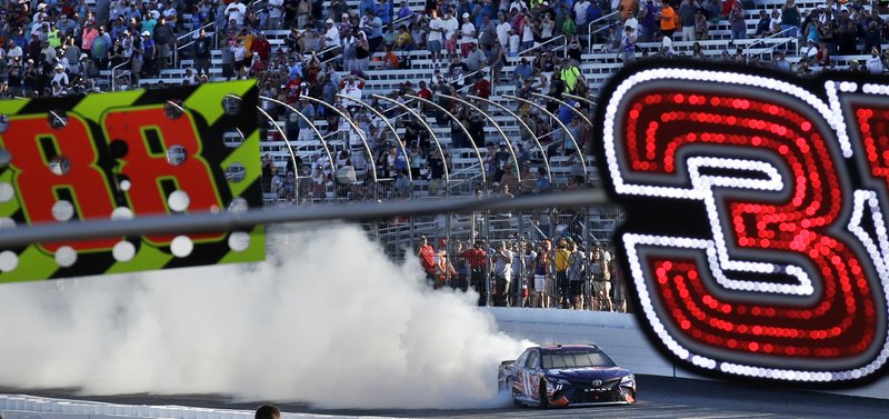 The Associated Press BURNING RUBBER: Driver Denny Hamlin smokes his tires as he passes fans after winning the NASCAR Cup Series 301 at the New Hampshire Motor Speedway in Loudon, N.H., Sunday.