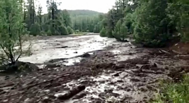 This Saturday, July 15, 2017, image from video provided by Scott Muller shows the flash flood just upstream of a popular swimming hole where it swept several people to their deaths in the Tonto National Forest near Payson, Ariz. 