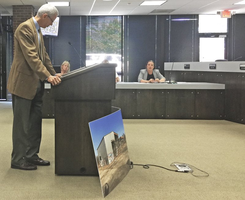 NWA Democrat-Gazette/TRACY M. NEAL Rogers attorney Bill Watkins (left), who represents Kingman Land LLC tells Rogers planning commissioners about a development on Stoney Brook Road sy the site of the former pallet factory.