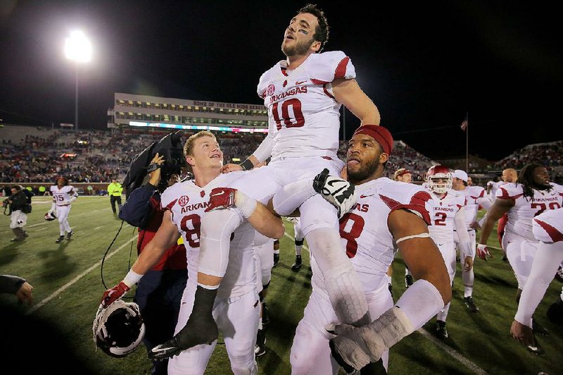 Quarterback Brandon Allen is carried off the field by teammates after his two-point conversion in overtime pushed Arkansas to a comeback victory over Mississippi. 