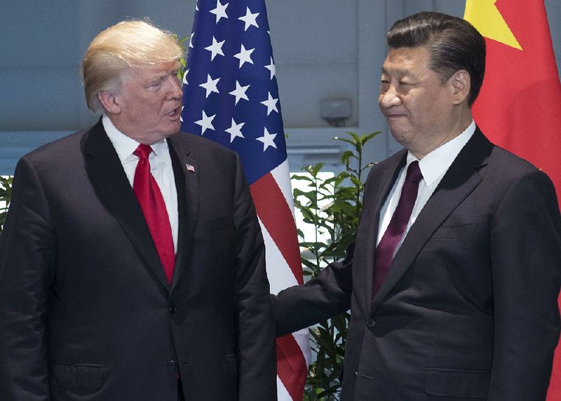 President Donald Trump (left) and Chinese President Xi Jinping meet at the G-20 Summit in Hamburg, Germany, on July 8. U.S. and Chinese trade officials are scheduled to meet today. 
