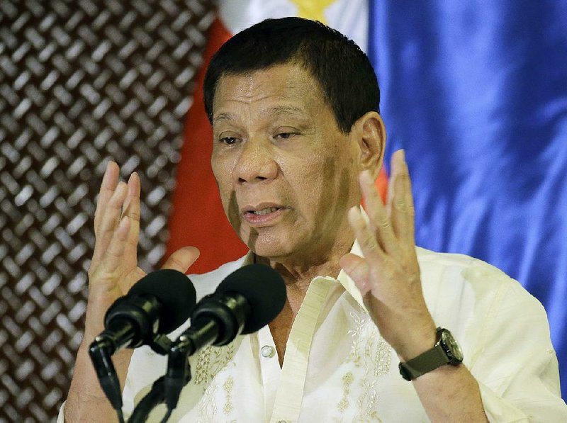 Philippine President Rodrigo Duterte speaks at a ceremony with the Philippines military Tuesday at the presidential palace in Manila, the same day he asked Congress to extend martial law in the country’s south. 