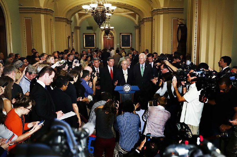 Senate Majority Leader Mitch McConnell (center) said Tuesday that while he regrets not being able to pass the Senate health care bill, “that doesn’t mean we should give up.” 