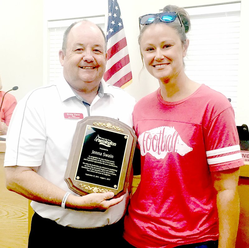 LYNN KUTTER/ENTERPRISE-LEADER Farmington Mayor Ernie Penn presents Jenna Swain, city parks director, with a plaque of appreciation. Swain leaves at the end of the month to earn a master&#8217;s degree in sports business management at the University of Alabama.