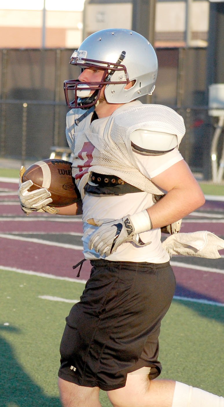 Graham Thomas/Herald-Leader Siloam Springs junior running back Dalton Ferguson runs back to the huddle after running for a 25-yard touchdown at a team camp at Panther Stadium last Thursday. Siloam Springs is scheduled to participate in a team camp at Rogers Heritage this Thursday.