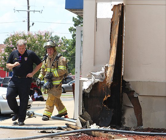 The Sentinel-Record/Richard Rasmussen RESTAURANT FIRE: Hot Springs Fire Chief Ed Davis, left, and Lt. Perry Allison work the scene of a small fire in a wall at IHOP, 3837 Central Ave., Tuesday afternoon.