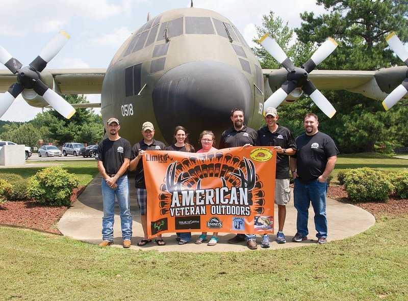 From left, Todd Banks, David Cagle, Michelle Doring, April Banks, Jason Pitts, Ben Hawkins and Jeremy Meadows, members of American Veteran Outdoors, pose at the Little Rock Air Force Base in Jacksonville. The nonprofit organization is dedicated to giving veterans an opportunity to enjoy the outdoors for free. The Heroes and Hot Rods fundraiser car show to benefit the organization will take place July 29 at Cabot High School.