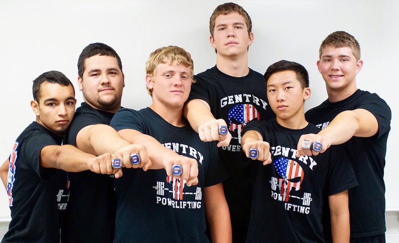 Gentry powerlifters Lawrence Caro, Tomas Gomez, Konner Hodges, Mason Clark, Khang Yang and Tanner Christie showed their championship rings which they received on July 12. Not pictured are Chance Cooper, Trey Welch, Seth Chaney, coach Kaven Fleshner and head coach Sean Seligman.