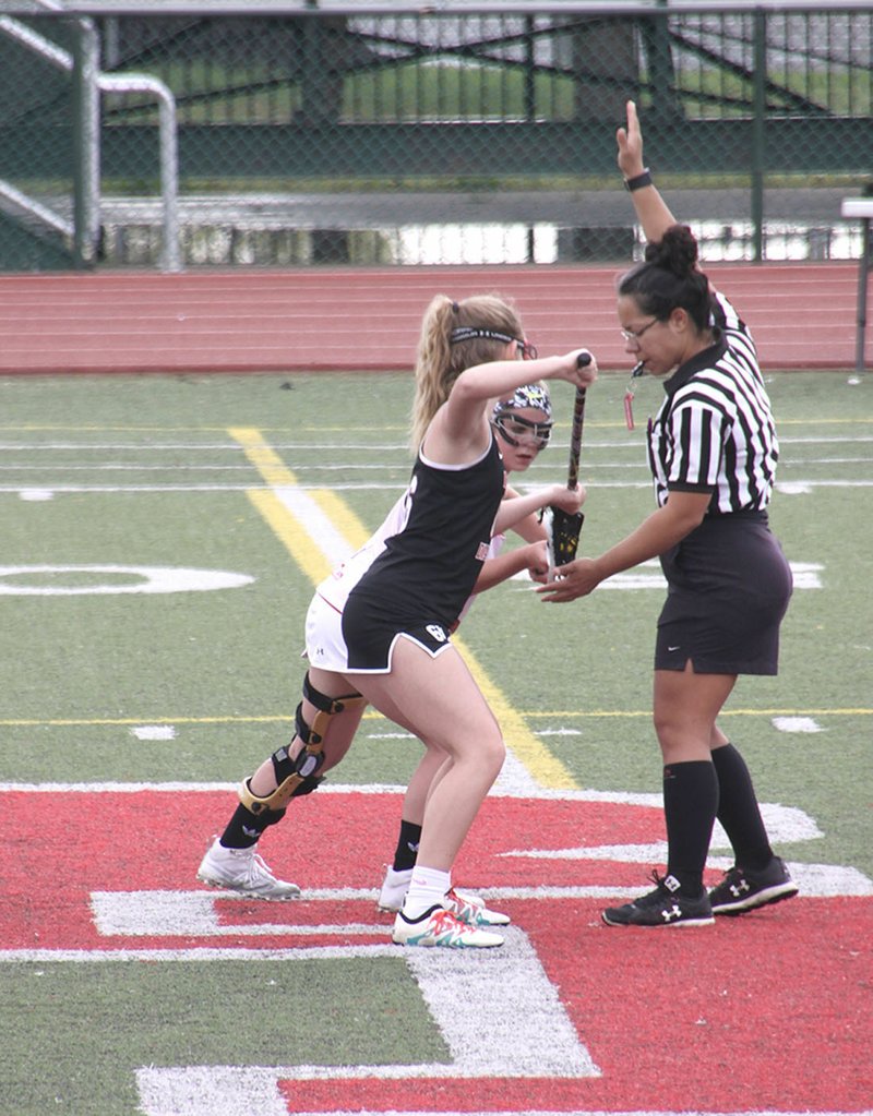 Courtesy photo Lucile Latham (foreground) of Bentonville prepares for a face-off during a lacrosse game against Jenks, Okla., last season.